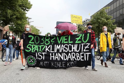 Demonstrators holding a banner with the inscription Climate protection is handiwork at the alliance