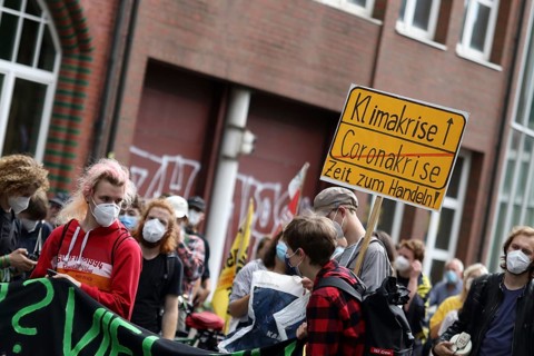 Demonstrators with a sign saying Climate Crisis at the alliance demo on climate racism and climate
