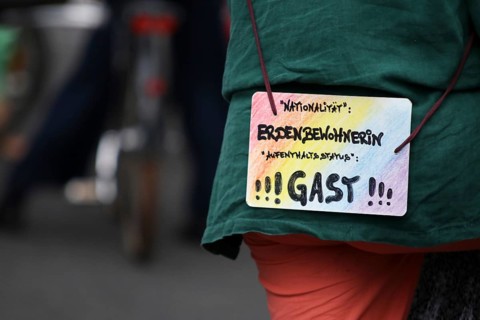 Sign of a demonstrator at the alliance demo on climate racism and climate flight, with, among
