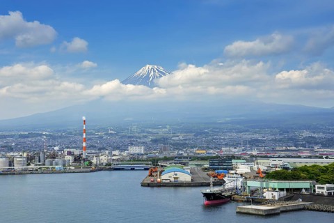 View over the city Fuji and Tagonoura Port with Mount Fuji in the background in spring, Shizuoka