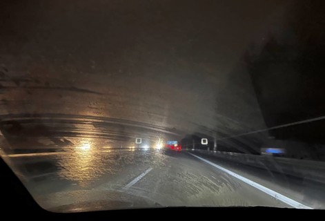 A dirty windscreen and old windscreen wipers obstruct visibility on the motorway