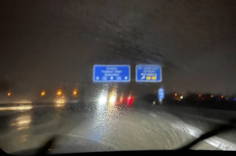 A dirty windscreen and old windscreen wipers obstruct visibility on the motorway