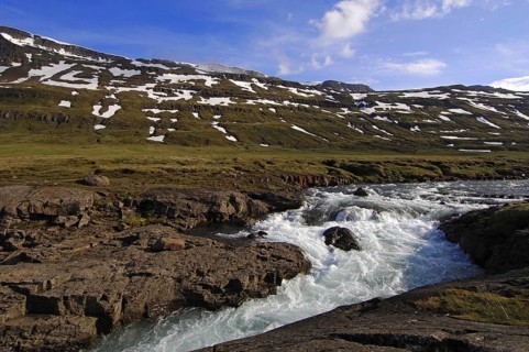 The Fjardara River swollen with spring melt-water, near Seydisfjordur, east Iceland