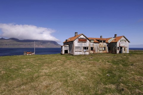 Old abandoned hospital building at the mouth of Faskrudfjordur in the East Fjords region of eastern