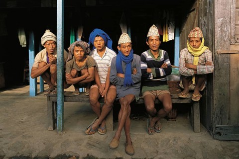 Group of village men waiting perhaps for work as porters in the village of Hille in east Nepal