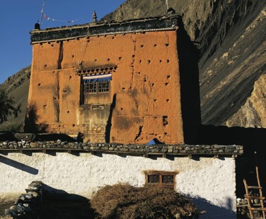 The village shrine or gompa with cliffs behind in the village of Kagbeni in southern Mustang in