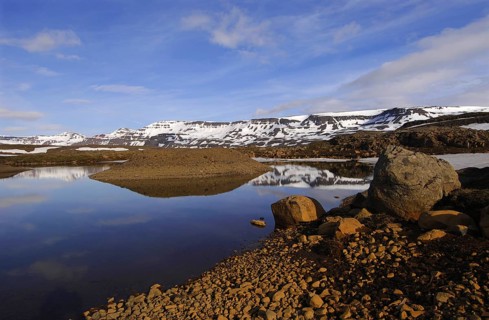 Rock-rimmed meltwater pool in the Fjardarheidi range near Seydisfjordur, east Iceland