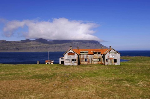 Old abandoned hospital building at the mouth of Faskrudfjordur in the East Fjords region of eastern