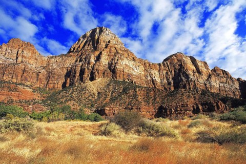 Rock peaks at the entrance to Zion Canyon, with red rock-faces and blue sky behind. Zion, Utah,