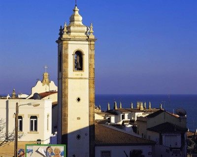 Early morning light on the houses and church of the old town of Albufeira, Algarve, Portugal,