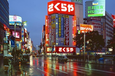 Neon-lit highrise buildings on a wet evening in Shinjuku entertainment district, Tokyo, Japan, Asia