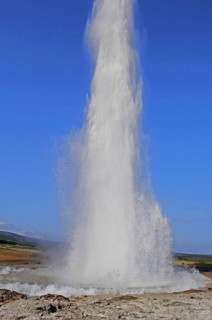 The geyser Strokkur fires steam and boiling water up to a height of around 20m, at Storr Geysir,