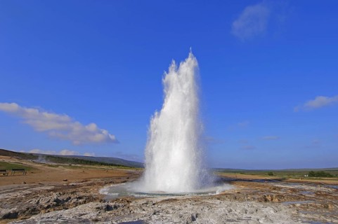 The geyser Strokkur fires steam and boiling water up to a height of around 20m, at Storr Geysir,