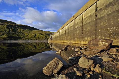 Hydro-electric dam and reservoir in Glen Lyon with pebbled shore and distant ridgeline, Glen Lyon,