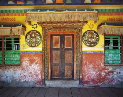 The entrance to the village gompa or shrine decorated with religious painting in the Tibetan style