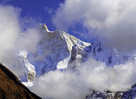 Afternoon mist and clouds gather around the dramatic peak of Jannu in the Kangchenjunga region of