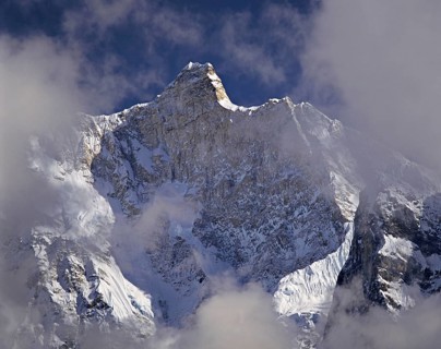 Afternoon mist and clouds gather around the dramatic peak of Jannu in the Kangchenjunga region of