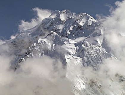 Afternoon mist and clouds gather around a peak known as The Twins in the Kangchenjunga region of