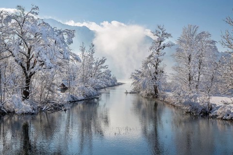 Winter landscape with outflow of the Loisach from the Lake Kochel in front of the Herzogstand