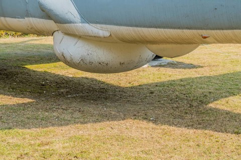 Sensor dome on bottom of military tracker aircraft on display in public park