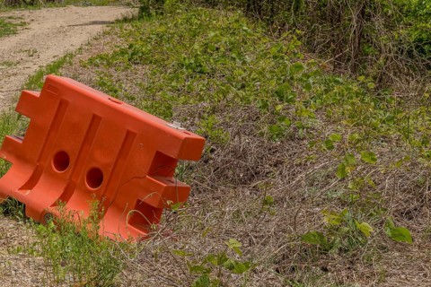 Orange plastic traffic barrier in remote wilderness area in South Korea