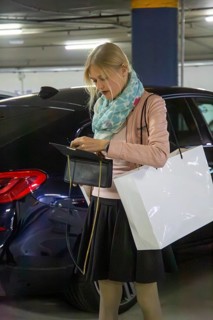 Elegant young woman in a car park