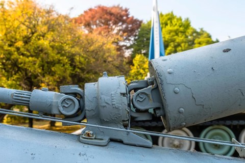 Closeup of intermediate gear box and u-joints of connecting tail rotor drive shaft on helicopter on