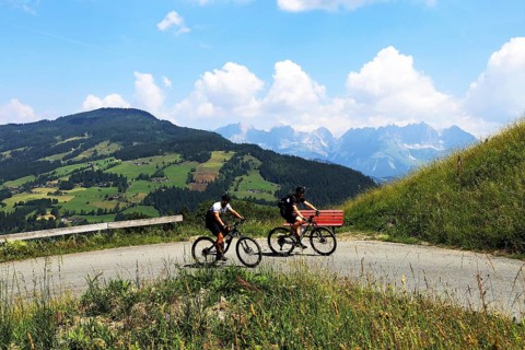 Mountain bikers in the Kitzbuehel Alps with alternating views of the Wilder Kaiser and the