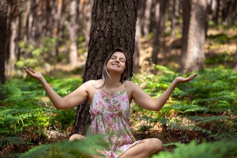 Young woman bathing in the forest (Shinrin Yoku), nature therapy from Japan