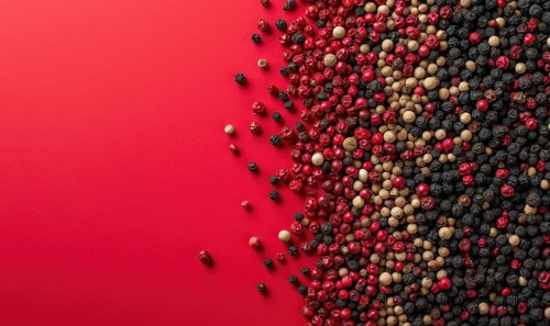 Top view of pink and black pepper peppercorns on pink background AI generated