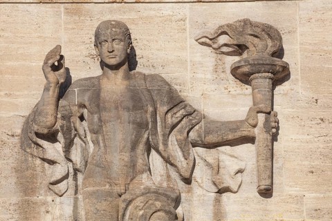 Bearer of the Olympic flame at the entrance portal, Olympic Stadium, 1936 venue of the Winter