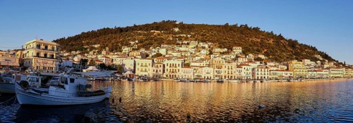 Fishing boats in front of a coastal town, captured in a panorama at dawn, morning light, Gythio,