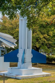 Lower portion of surface to air missiles behind tree branches in a public park