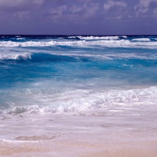 Waves in a storm on La Digue at Grand Anse beach, Seychelles, Africa