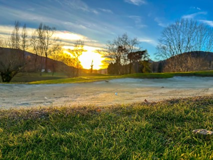 Golf Ball in a Sand Trap on Golf Course in Sunset in a Sunny Day in Switzerland
