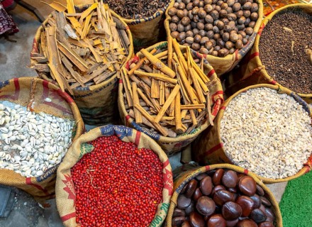 A bird's-eye view of sacks with various colorful spices and herbs for sale at a market in Fort