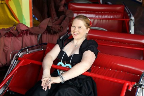 Cheerful woman travelling up and down the mountain at the Brezelfest in Speyer,