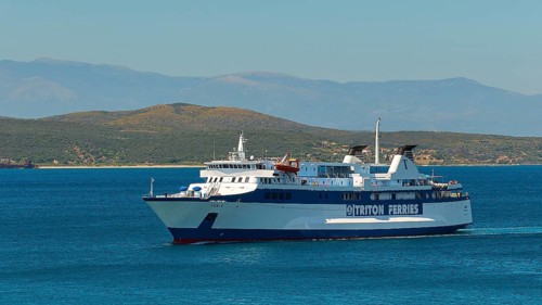 Large white ferry on blue sea with clear sky, en route to a destination, Gythio, Mani, Peloponnese,