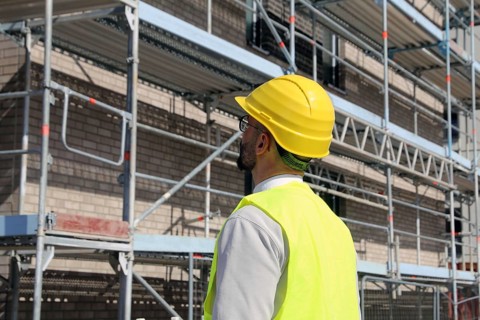 Symbolic image: Architect in front of an apartment block under construction
