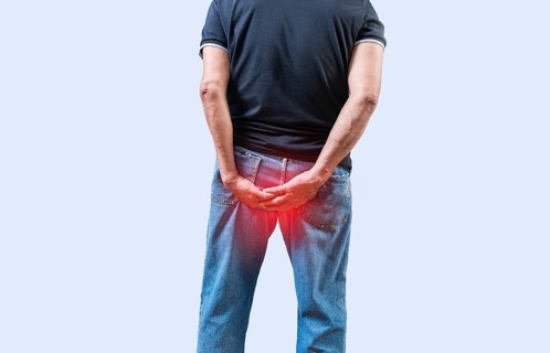 Person with hemorrhoid problem isolated. Elderly people with digestive problem touching his
