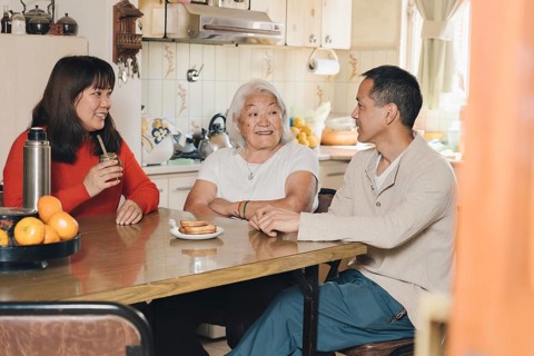 Japanese Family talking and drinking yerba mate at home. Argentinian family of Japanese descent