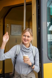 Young woman boarding a train