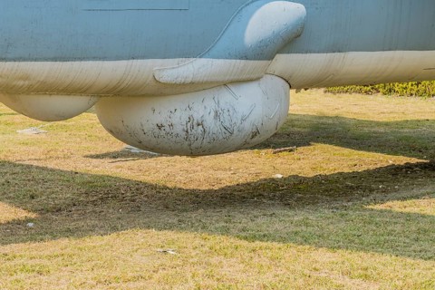 Starboard view of sensor dome on bottom of military tracker aircraft on display in public park