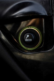 Vertical Close up of the car cigarette lighter socket.modern car interior: parts, buttons, knobs