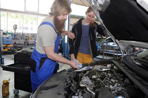 Symbolic image: Car mechatronics technician with customer in the garage