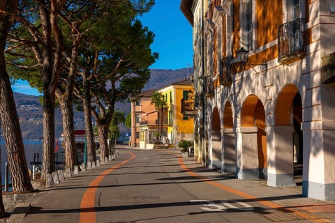 Old Beautiful Town with Building and Trees on the Waterfront on Lake Lugano in a Sunny Day with