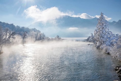 Winter landscape with outflow of the Loisach from the Lake Kochel in front of the Herzogstand