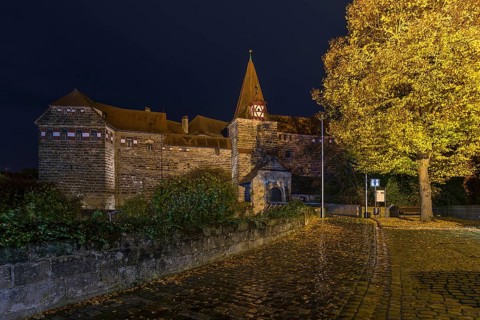 Wenzelburg or Lauf Imperial Castle illuminated at night on a rainy autumn day, rebuilt by Emperor