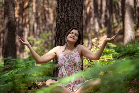 Young woman bathing in the forest (Shinrin Yoku), nature therapy from Japan