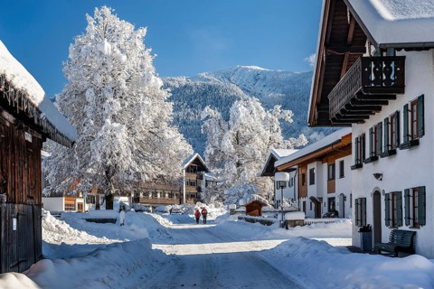 Winter village street with Heimgarten 1791m, Ohlstadt, Loisachtal, The Blue Country, Bavarian Alps,